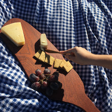 Load image into Gallery viewer, Nifty Spreading Knife being used to cut cheese on a charcuterie board. Picnic blanket background. 
